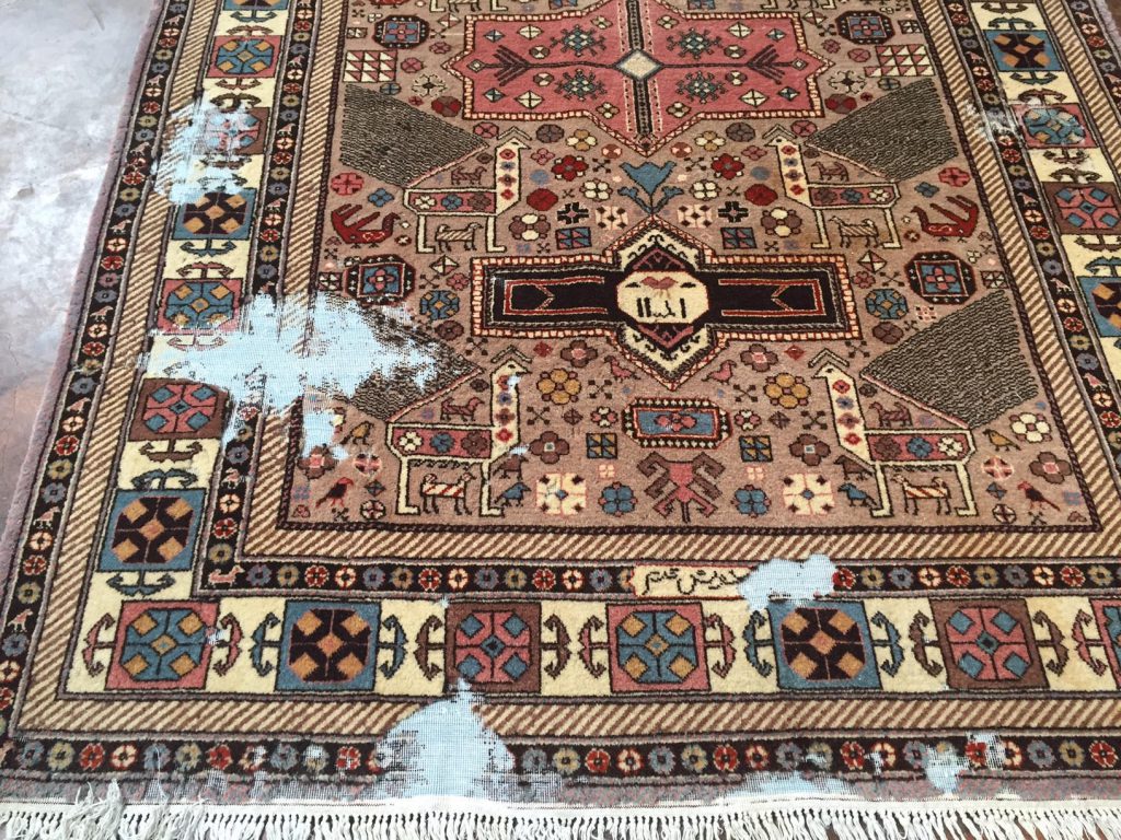 Fine handmade Persian rug with moth damage